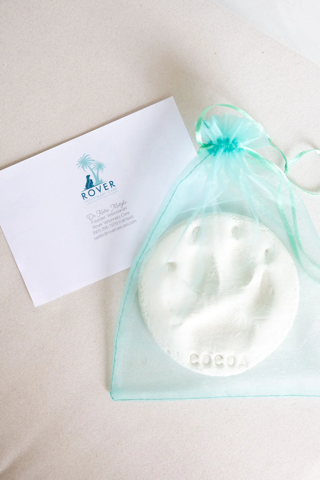 A Rover clay pawprint keepsake in a gift pouch