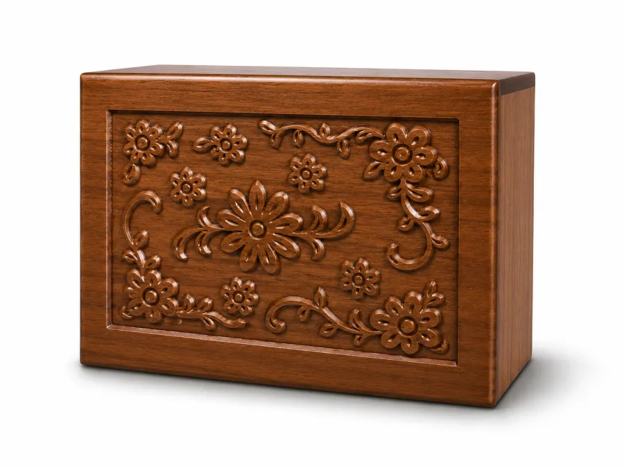 Carved wood pet cremation urn with a hand-carved floral design